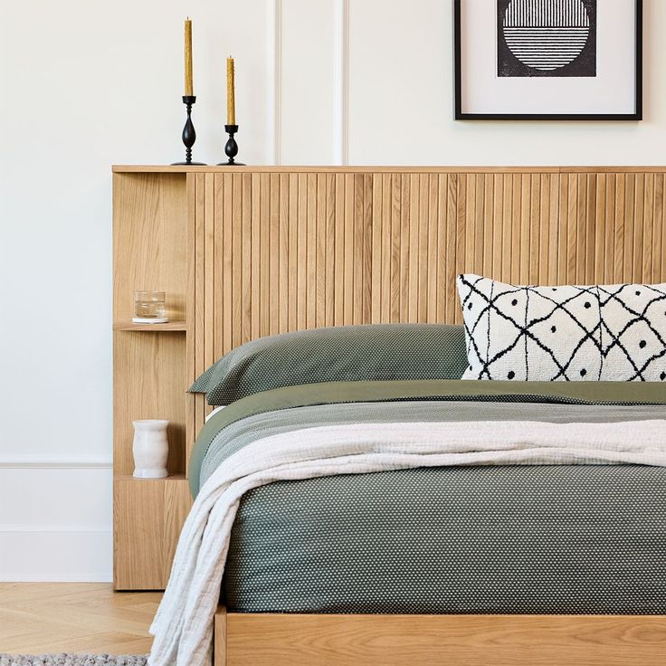 a bed with a wooden headboard and night stands