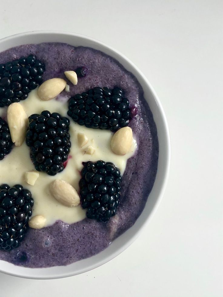 a bowl filled with blueberries, almonds and yogurt