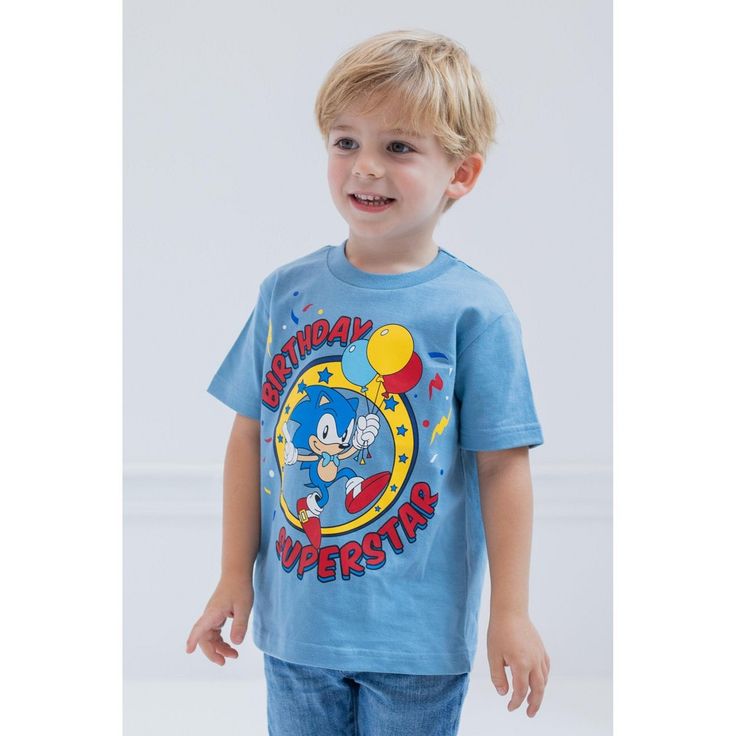 Celebrate your special day in this stylish Sonic the Hedgehog birthday shirt! This cute short sleeve tee features the words "Birthday Superstar" and colorful artwork of your kid's favorite speedy video game character holding birthday balloons. Dressed in this soft and comfy Sega Sonic the Hedgehog tshirt, your little gamer is ready for an exciting birthday adventure! Birthday Multicolor Cartoon Print T-shirt, Cute Blue T-shirt For Birthday, Blue Short Sleeve T-shirt, Sonic The Hedgehog Birthday Shirt, Hedgehog Birthday, Video Game Character, Soft Clothes, Colorful Artwork, Clothing Material