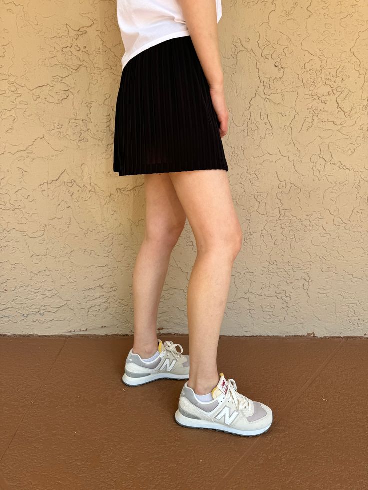 Elevate your fashion game with the Rally Club Maria Pleat Skirt in Black. This stylish tennis skirt combines performance and fashion for the court or casual wear. The pleated design adds a touch of elegance and enhances mobility, allowing you to move freely on the court or the street. Whether you're playing a match or running errands, this skirt is a versatile and chic choice for any occasion. Fabrication: Skirt 100% Polyester / Short Lining 82% Polyester, 18% Lycra - Details: - Pleated skirt - Ladies Who Lunch, Pleat Skirt, Bag Dress, Tennis Skirt, The Court, Running Errands, Fashion Games, Pleated Skirt, Shirt Shop