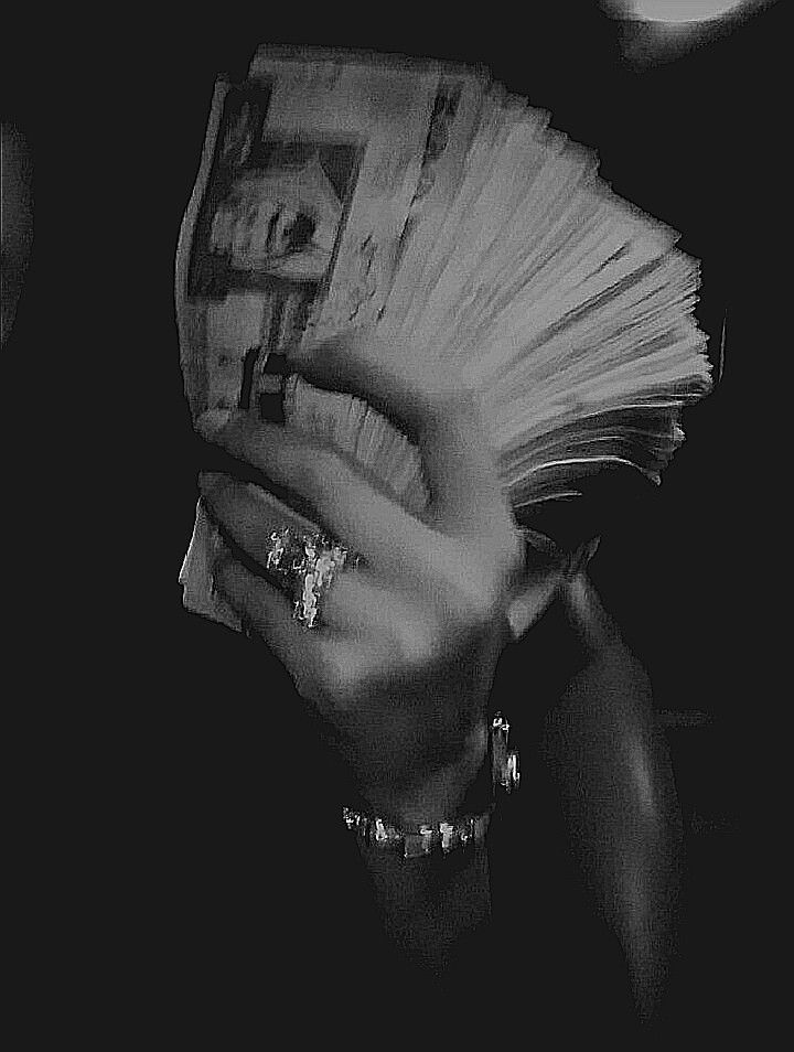 black and white photograph of a woman holding money