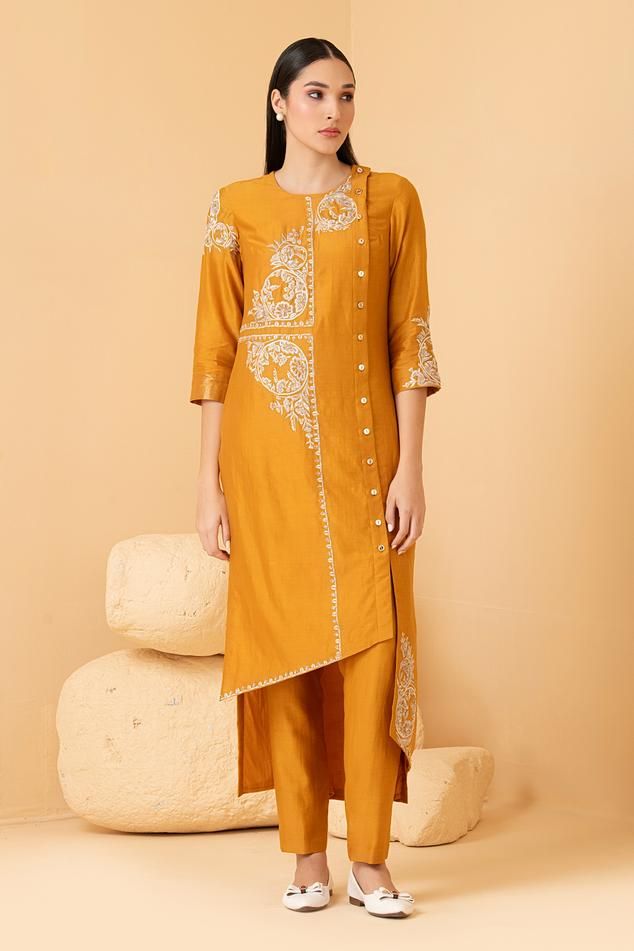 Mustard tunic with zari, sequin, pearl embroidery in floral pattern. Paired with pant.
Components: 2
Pattern: Embroidery
Type Of Work: Zari, sequin, pearl, floral
Neckline: Round
Sleeve Type: Three quarter
Fabric: Pure Chanderi
Color: Yellow
Other Details: 
Front button detailing
Attached lining
Length:
Sleeves: 18 inches
Weight: 1.5 kgs
Occasion: Mehendi and Haldi - Aza Fashions Festive Designer Pant Set With Dabka Work, Designer Dabka Work Pant Set For Diwali, Designer Zari Work Pant Set For Festive Occasions, Eid Pant Set With Zari Work And Traditional Drape, Traditional Drape Pant Set With Zari Work For Eid, Designer Raw Silk Pant Set With Zari Work, Designer Zari Work Pant Set For Eid, Eid Designer Pant Set With Zari Work, Designer Eid Pant Set With Zari Work