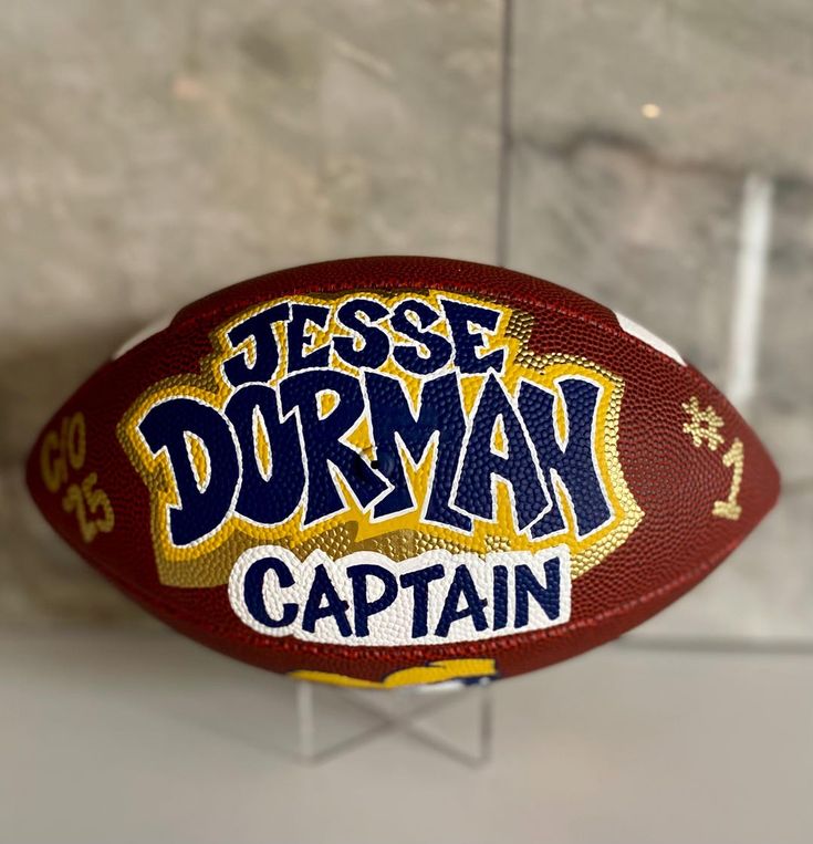 a close up of a football with the words jese dorman captain on it