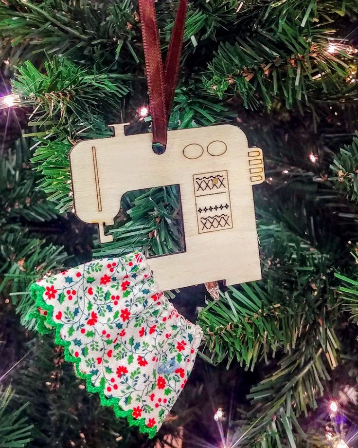 an ornament hanging from a christmas tree with two pieces of fabric on it