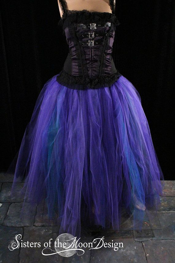 a woman wearing a purple and black corset on top of a stone floor