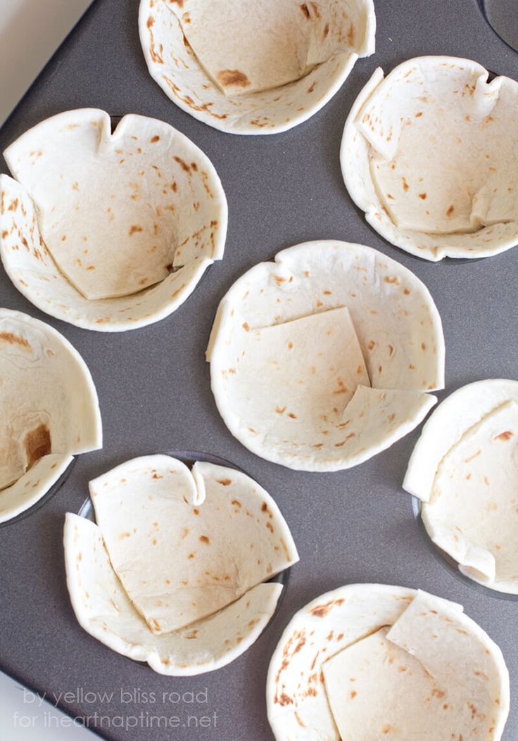 six tortilla shells sitting on top of a pan