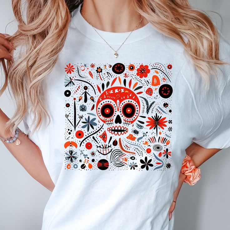 Step into a realm of whimsy and comfort with our latest collection, where the Boho-Skeleton meets Hippie-Comfort in a dazzling display of Colorful-Bohemian artistry. Each Skeleton-Shirt and Boho-Tee is a canvas of imagination, blending the carefree spirit of a Hippie T-shirt with the soft embrace of Comfy-Cotton. Our Comfort Colors range is more than just clothing; it's an experience in relaxed elegance, perfectly captured in each Relaxed Fit-Shirt. Dive into the mystical world of Fantasy Mushrooms and Enchanted Forests, artistically rendered on our tees, bringing a touch of magic to your wardrobe. The Artistic Tee collection, adorned with Psychedelic Art, is a tribute to those who dare to dream and live in color. Our t-shirts are not just garments; they're gateways to worlds unseen, a cel Multicolor Skull Print Summer Tops, Multicolor Skull Print Top For Summer, Multicolor Skull Print Tops For Summer, White Skull Print Shirt For Summer, Festival Crew Neck T-shirt With Graphic Print, White Shirt With Skull Print For Summer, Bohemian Red Cotton T-shirt, White Bohemian Crew Neck Top, Festival Skull Print Short Sleeve Tops