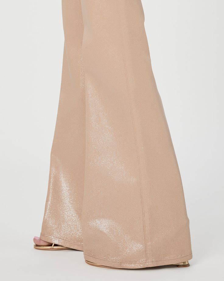 This 90s-inspired sleek wide leg is designed with a high-rise and a flattering bow leg silhouette. It has a glittery, leather-like look, but doesn’t sacrifice comfort. Cut from our coated TRANSCEND denim in a beige and silver glitter ombre luxe coating, this style is luxuriously soft with plenty of stretch and recovery to give it a fit that shines all day and night. | Leenah Wide Leg Jean - Latte/Silver Glitter Ombre Luxe Coating Coat | Size 26 Glamorous Wide Leg Pants For Evening, Elegant Metallic Bottoms For Evening, Chic Wide Leg Cocktail Bottoms, Elegant Flare Wide Leg Pants For Party, Elegant Flared Wide Leg Party Pants, Elegant Gold Wide Leg Pants For Party, Shiny Wide Leg Evening Bottoms, Shiny Wide Leg Bottoms For Evening, Metallic Wide Leg Pants For Party