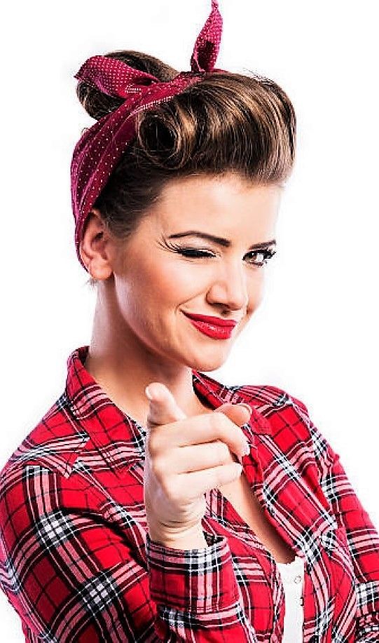 a woman wearing a red and black checkered shirt with a bow in her hair