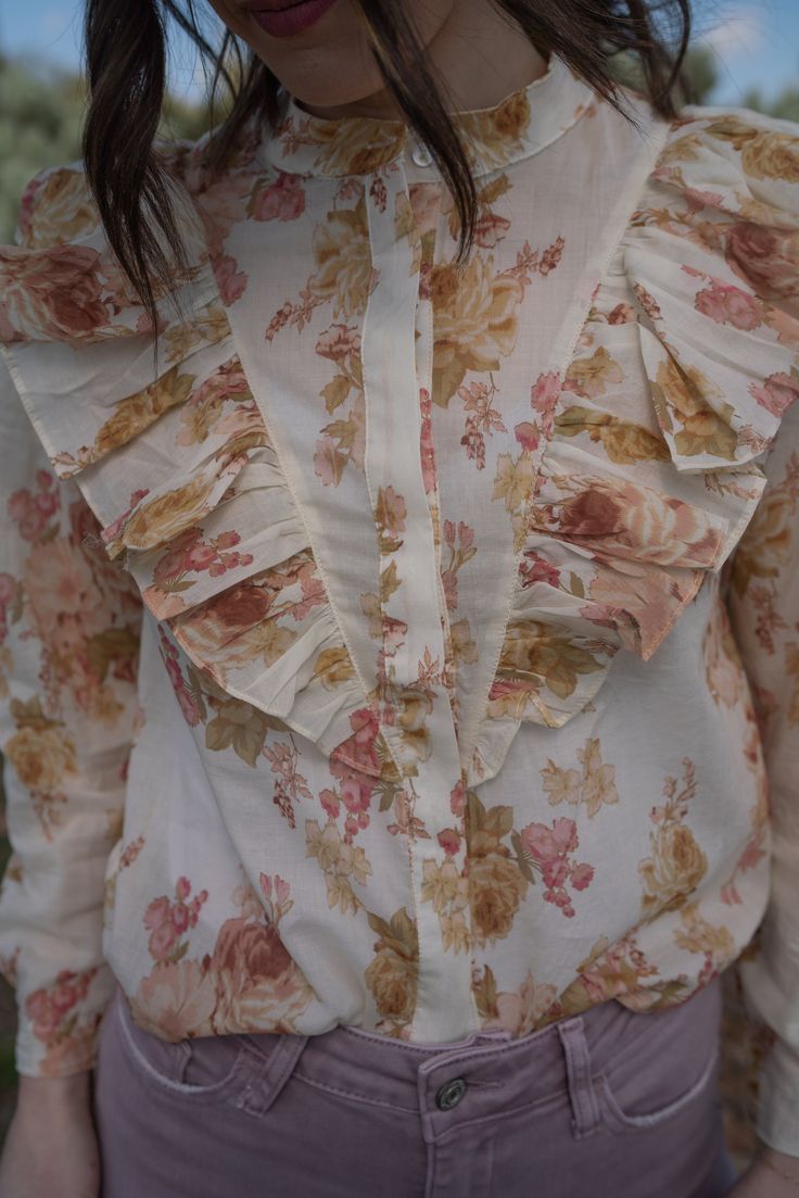 We are really stepping up our blouse game this spring! Florals are forever our favorite pattern. Victorian style top Front button down closure Ruffle detail 100% polyester Long sleeve that comes shorter than the wrist Models are 5'4" and wearing a size small. The length of a size small is 19.5". Small: 2-4 Medium: 6-8 Large: 10-12 Feminine Long Sleeve Shirt For Spring, Spring Floral Print Blouse With Collar, Spring Floral Print Collared Blouse, Spring Floral Print Collared Tops, Spring Collared Blouse For Workwear, Feminine Floral Print Button-up Shirt, Spring Workwear Blouse With Collar, Spring Workwear Collared Blouse, Feminine Floral Print Shirt For Daywear