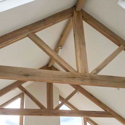 the inside of a building with wooden beams