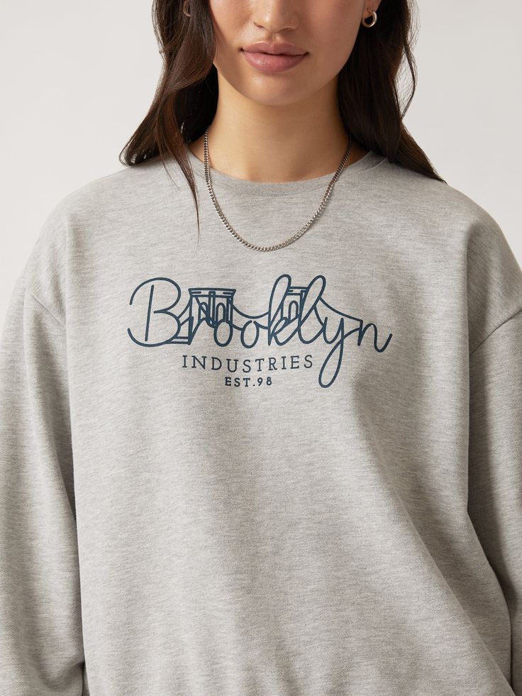 Our Brooklyn Bridge crewneck features an illustrated graphic across the chest. Its relaxed fit and dropped shoulders make it an easy layer, while the brushed fleece backing is soft enough to wear alone. #B1S10137-80018 Fabric: 100% cotton Casual Boxy Crew Neck Sweatshirt, Cotton Graphic Print Sweats For Loungewear, Graphic Print Crew Neck Sweatshirt For Loungewear, Graphic Print Crew Neck Sweater For Loungewear, Relaxed Fit French Terry Tops With Text Print, Loungewear Graphic Print Crew Neck Sweater, Trendy Boxy Fit Crew Neck Sweatshirt, Winter Graphic Print Crew Neck Sweats, Graphic Print Crew Sweats