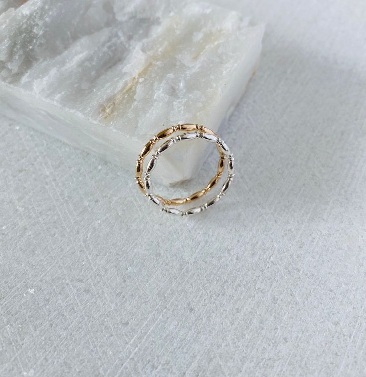 This unique textured ring band will be handmade to order in your size. Each ring is made with the long oval beads that are connected to the spacer beads creating an eye catching intricate detail. Wear this band on its own, stack with other bands or use as a spacer ring. DETAILS Band width: 1.3mm 14k gold filled or Sterling silver Dainty 14k Gold Toe Ring, Silver Gold-plated Stackable Promise Rings, 14k Gold Hypoallergenic Stackable Rings For Promise, Dainty Stackable Bands, Elegant Silver 14k Gold Filled Rings, Dainty Rose Gold Stackable Rings Tarnish Resistant, Dainty Rose Gold Tarnish Resistant Stackable Rings, Dainty Rose Gold Tarnish-resistant Stackable Rings, Dainty Stackable Bands For Promise Ring