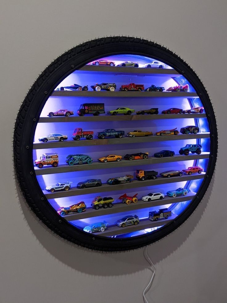 there is a circular display with cars in the center and blue lights on it's sides