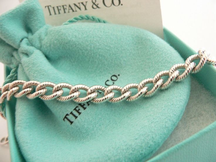 Offered for sale is a wonderful and rare Tiffany and Co. Sterling Silver "I Love You" Heart Padlock bracelet. The piece is made from substantial and bright Tiffany silver, and yet retains a very feminine feel to it. Attached to its very substantial Tiffany Silver Textured charm bracelet is a Heart padlock charm with "I Love You" written in beautiful script. The "I Love You" heart padlock charm opens and closes and thus can be used as a charm on a necklace or as part of another charm bracelet! Su