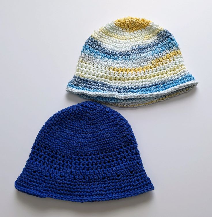 two crocheted hats sitting next to each other