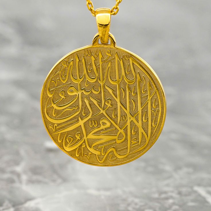 Crafted with exquisite detail and religious reverence, the First Kalima Necklace exudes elegance and spirituality. This Islamic necklace features the First Kalima inscribed in Arabic on a pendant made of 925 sterling silver and delicately plated with 18K gold. Designed especially for women, this Muslim jewelry piece serves as a meaningful adornment and a cherished gift. The intricate craftsmanship and the fusion of symbolic elements make this necklace a unique and timeless accessory. Elevate you Amulet Style Engraved Necklace For Anniversary, Engraved Amulet Necklace For Anniversary, Engraved White Gold Spiritual Jewelry And Charms, Traditional Pendant Jewelry For Commemoration, Engraved Spiritual Medallion Jewelry, Engraved Coin-shaped Spiritual Jewelry And Charms, Spiritual White Gold Necklaces For Commemoration, White Gold Spiritual Necklaces For Commemoration, Traditional Coin Medallion Necklace As A Gift