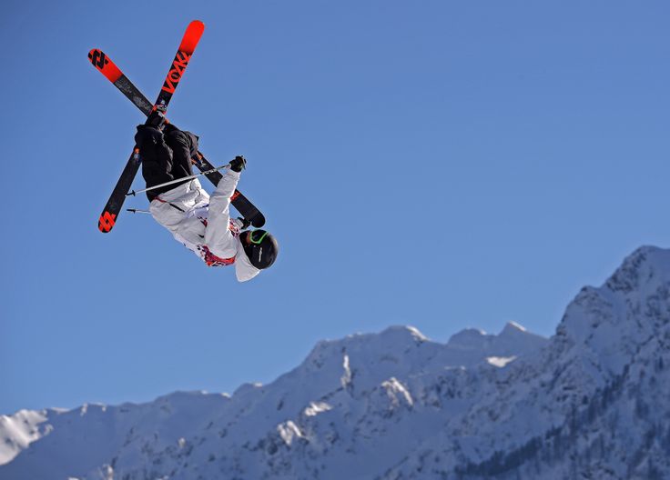 a man flying through the air while riding skis