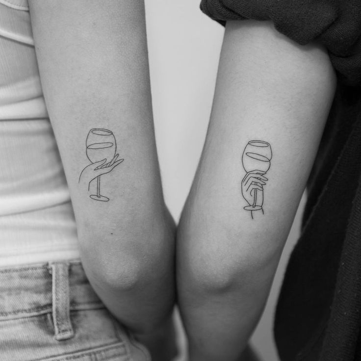 two people with matching tattoos on their arms