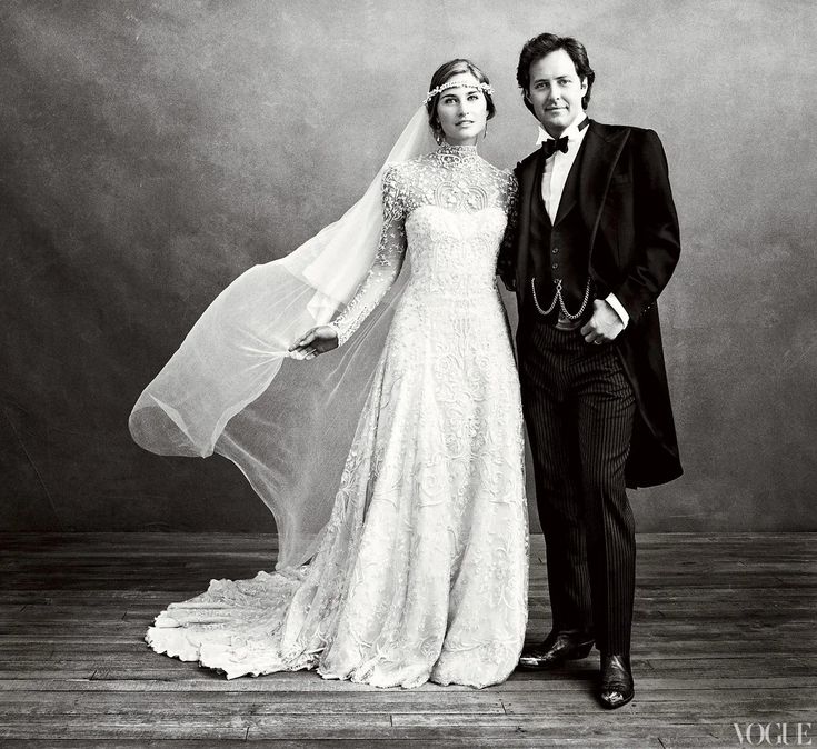 a bride and groom pose for a black and white photo