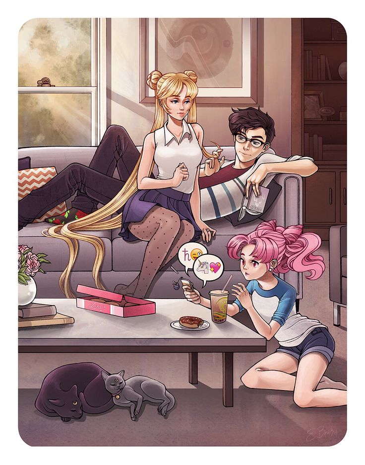 three people sitting on a couch in front of a cat