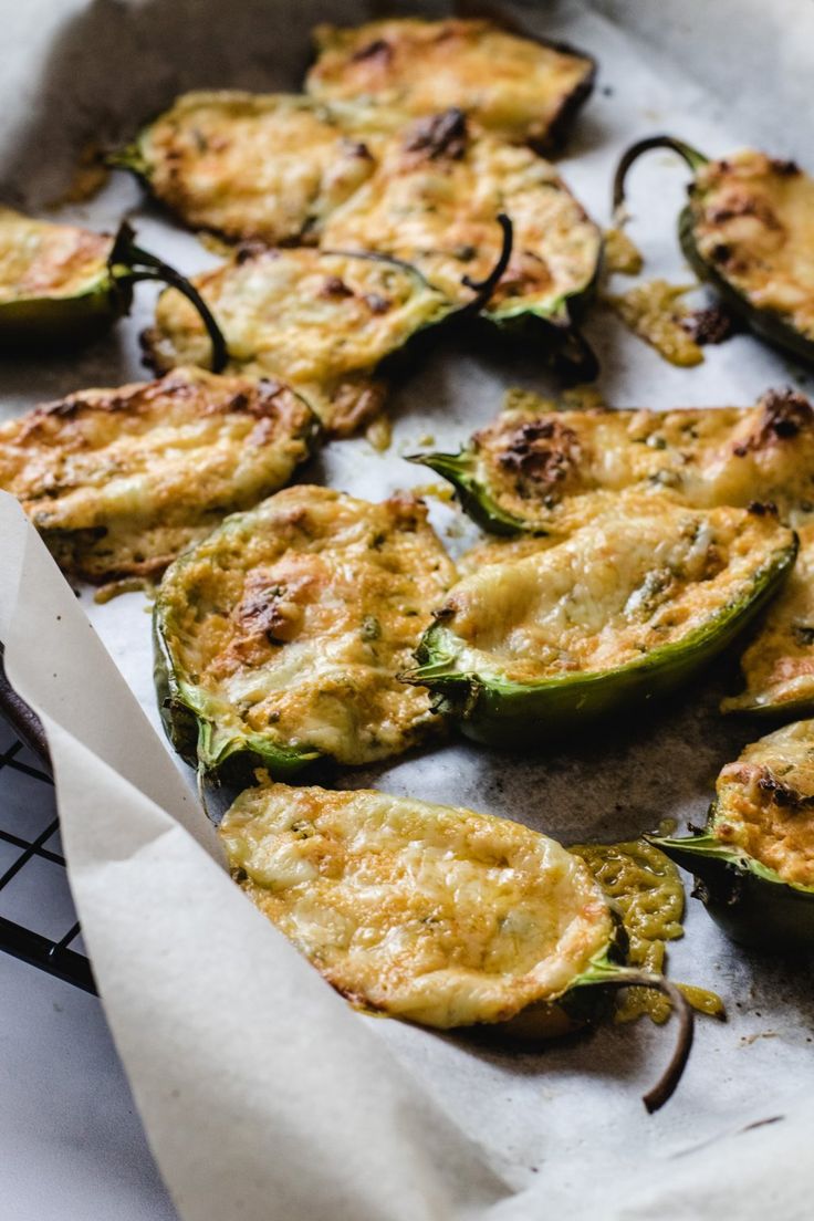 some green peppers are sitting on a tray and ready to be cooked in the oven