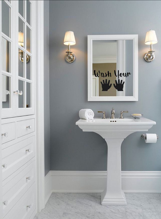 a bathroom with gray walls and white fixtures on the bottom right hand corner is an instagram post about paint colors