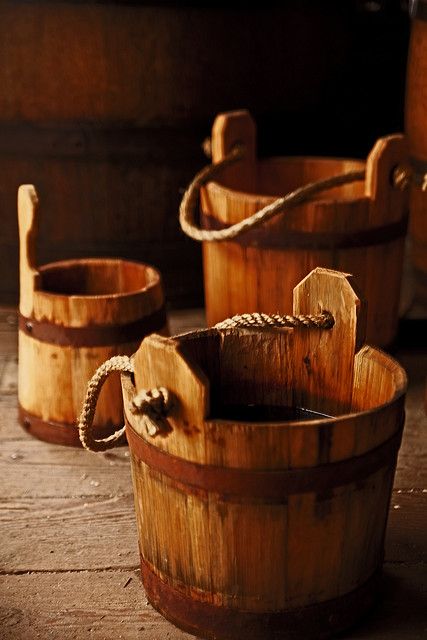 three wooden buckets sitting on top of a wooden floor