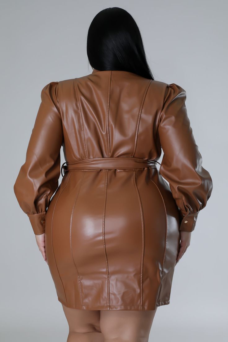 a woman in a brown leather dress and heels is looking down at the back of her body