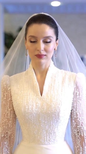 a woman wearing a wedding dress and veil