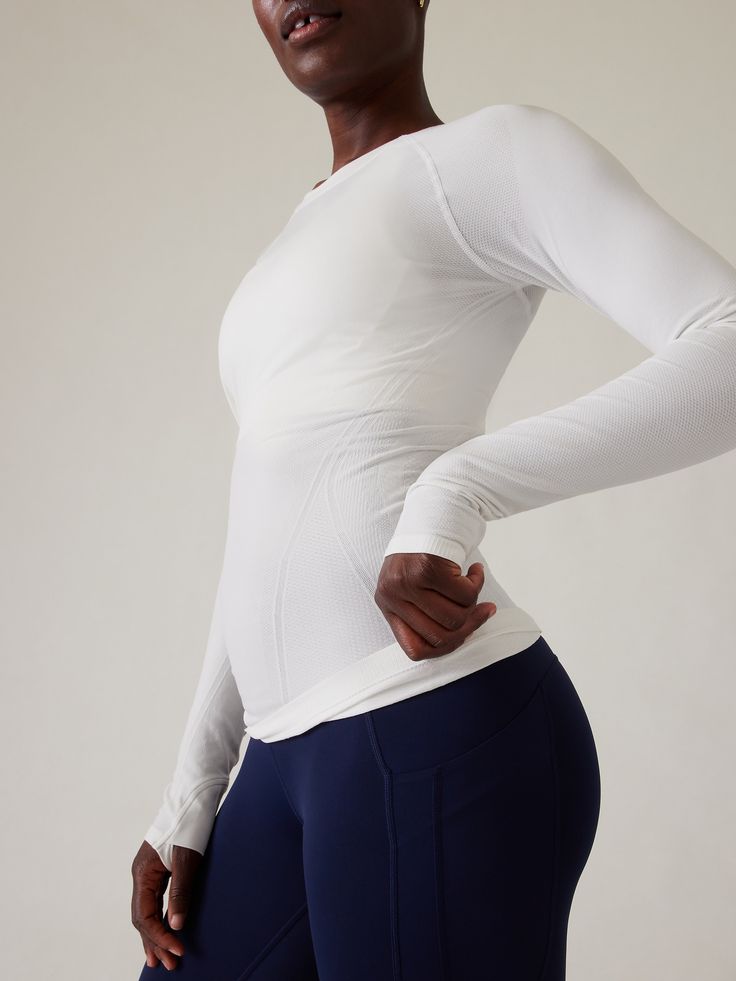 FOR: Medium to high-impact workouts at the gym, studio or outdoors FEEL: Seamless construction for maximum comfort and minimal chafing FAVE: Grippers at inner hem to prevent it riding up Thumbholes hold sleeves in place and keep warmth in Fitted next to body, hip length Body length in size medium: Regular: 25.75" Plus: 26". White Activewear With Go-dry Micro-elastic Fit, White Micro-elastic Activewear For Workout, White Sporty Activewear With Thumbholes, Workouts At The Gym, Gym Studio, Base Layer Women, Sweaty Workouts, Seamless Top, Layered Long Sleeve