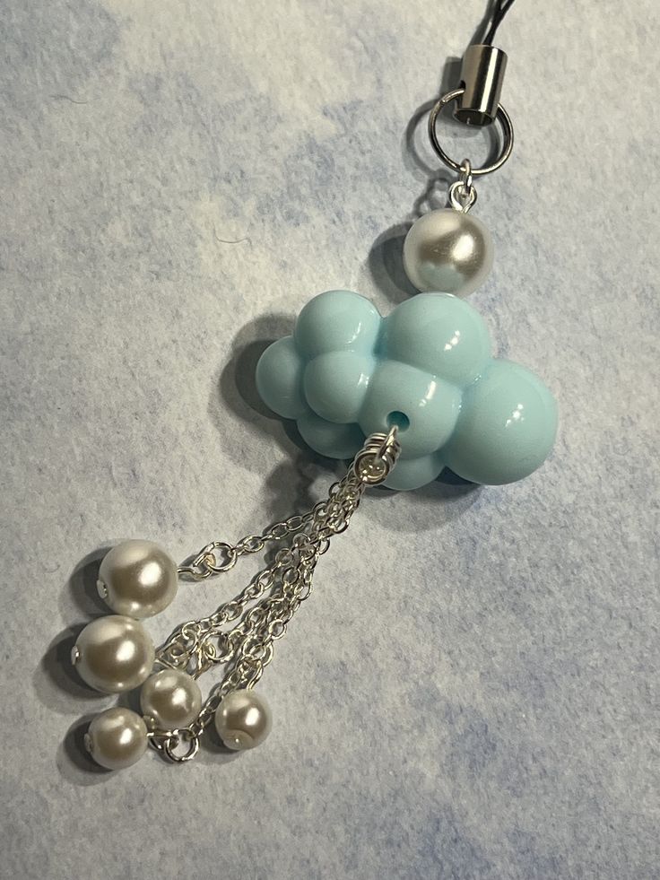 a key chain with pearls attached to it