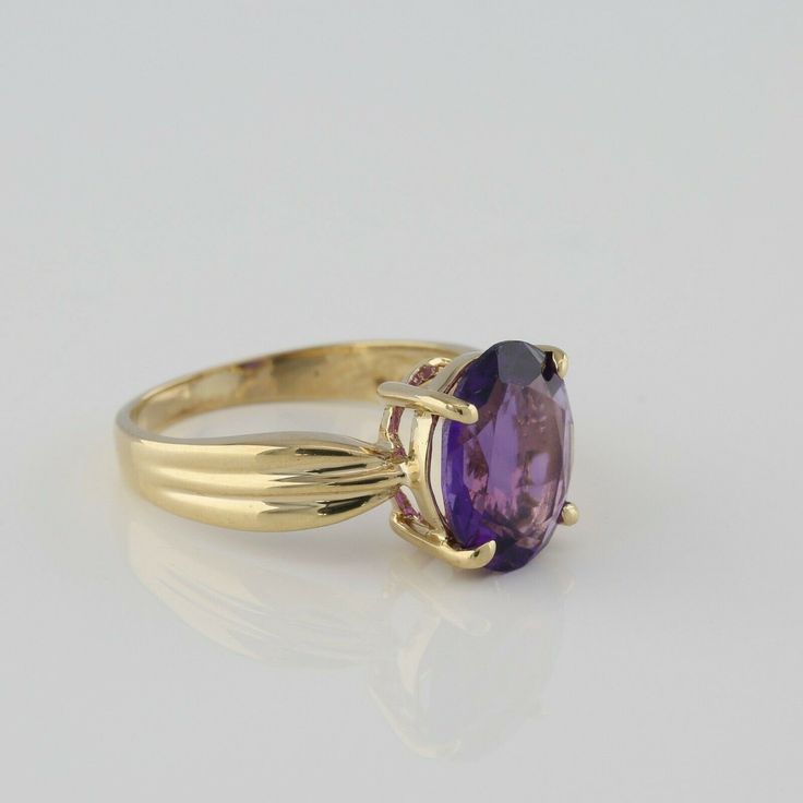 10K Yellow Gold Amethyst Solitaire Ring, oval faceted rich purple amethyst, 8.5 x 10.5mm, folded ribbon top shank, 3/8 inch across, Ring size 5 7/8, Circa 1970, 2.8 grams SKU# BB280R13 This listing contains photographs of the actual item you will receive. Our items are in excellent condition with little or no signs of wear and many are one of a kind pre-owned estate finds. Please look closely at the pictures in this listing as they are part of the product description. Please read the description Oval Amethyst Ring, Ribbon Top, Rich Purple, Amethyst Gem, Purple Band, Amethyst Jewelry, Ring Oval, Fine Jewelry Designers, Yellow Gold Earring