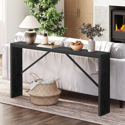 a living room with a couch, coffee table and fire place in the fireplace area