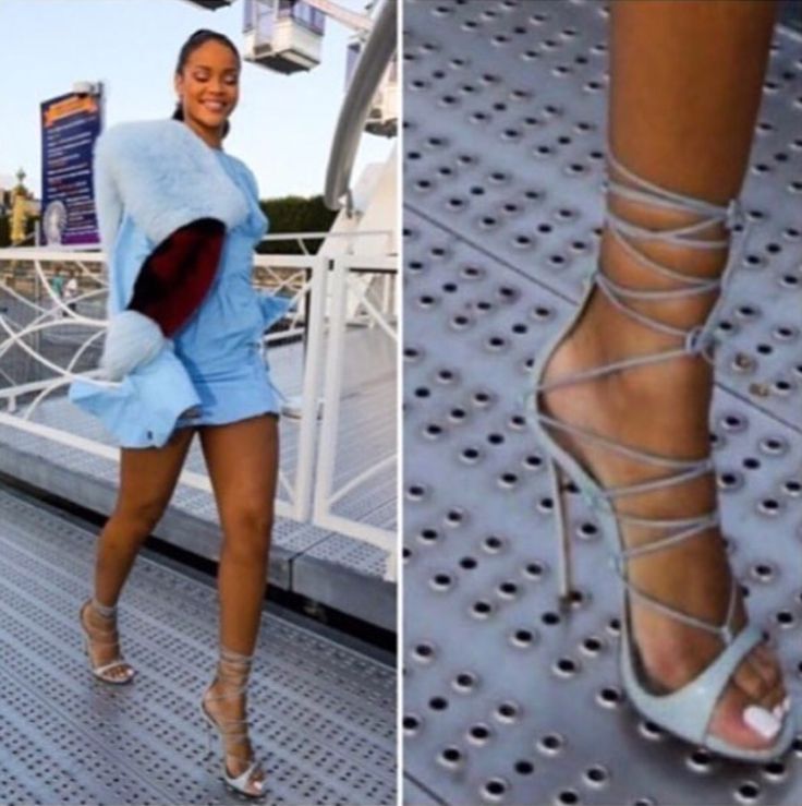 a woman in high heels standing on top of a metal platform next to another woman's legs