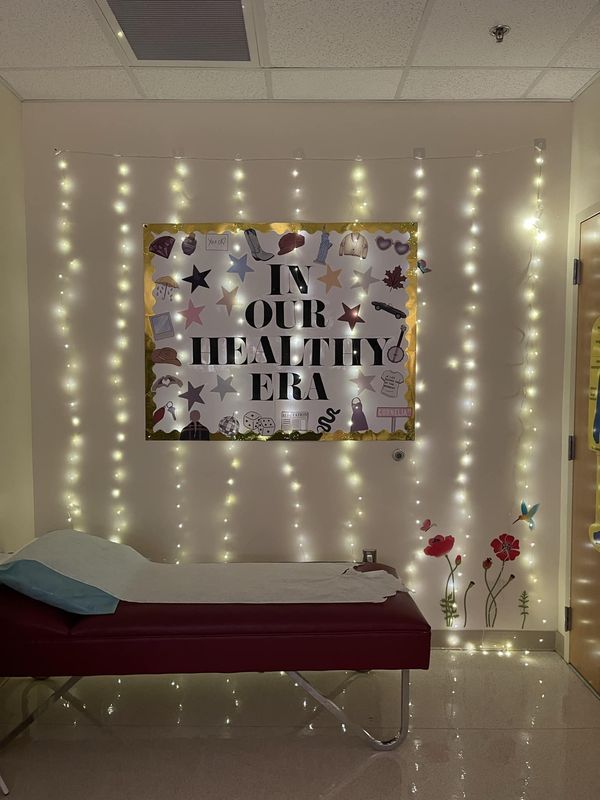 a bed in a room with lights on the wall and a sign above it that says in our healthy era