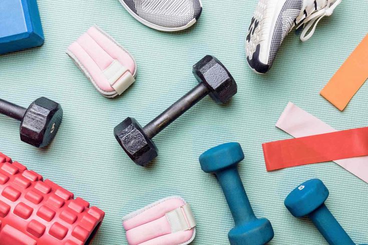 there are many different types of dumbs and exercise equipment on the floor with each other