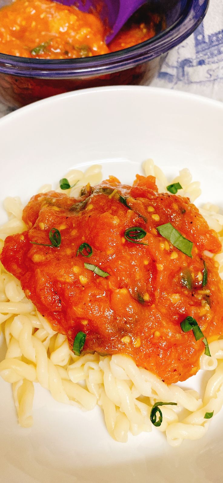 a white plate topped with pasta and sauce