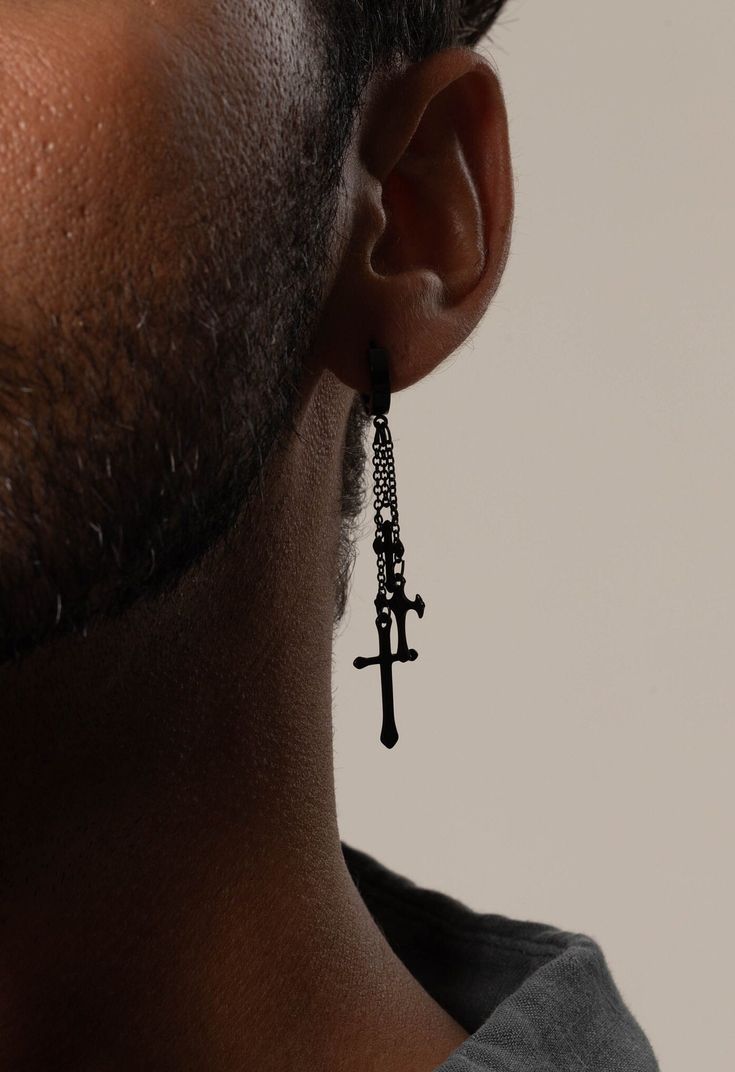 Enhance your style with our Dangle Drop Blacken Cross Hoop Earrings, perfect for the modern man. These Minimalist Cross Hoop Earrings offer a sleek and versatile design that complements any outfit. Crafted for comfort and durability, these Men's Drop Earrings feature a huggie style that ensures a secure fit. Whether you're dressing up for a special occasion or adding a touch of elegance to your everyday look, these Stylish Earrings for Men are the ideal choice. - Made to order - Materials: Stainless Steel - Color: Black Plating - SKU: MME9 Please note, the listing is for one ring. Any images featuring multiple rings are for illustrative purposes only. Please contact us with any questions or concerns. We will always do our very best to leave you a happy customer. All inquiries will receive Simple Cross Earrings Dangle Black, Men Dangling Earring, Black Single Earring For Streetwear, Black Dangle Single Cartilage Earring, Single Black Stainless Steel Hoop Earring, Dangling Earrings Men, Mens Dangle Earrings, Mens Earrings, Earrings Men