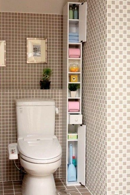 a white toilet sitting in a bathroom next to a shelf filled with books and magazines