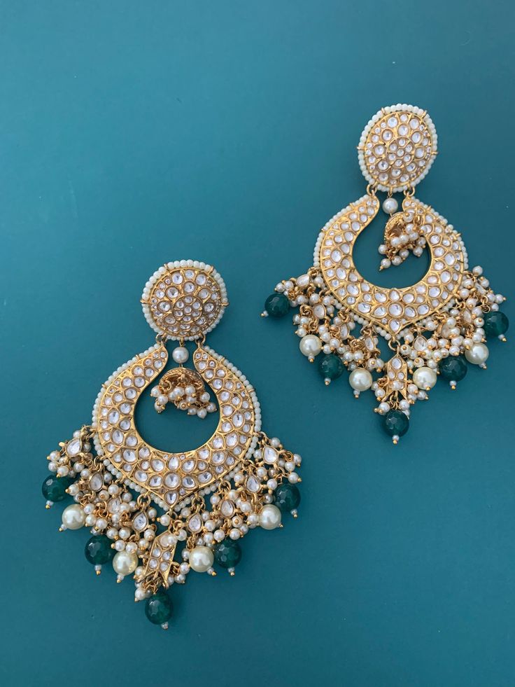 Super trendy Tyaani Kundan earring. Gold plated and stone embedded. Pearl lining and glass drop in purple can be customized (the drop). Back screw and clip to hold it in place. Very light weight. About four inch long and 2 inch wide. Stone Work Drop Earrings For Reception, Gold Chandelier Earrings With Stone Work, Gold Fusion Chandelier Earrings With Stone Work, Stone Work Drop Danglers For Reception, Reception Stone Work Dangle Earrings, Stone Work Danglers For Reception, Kundan Pearl Drop Danglers, Jeweled Chandbali Earrings For Reception, Jeweled Kundan Earrings For Reception