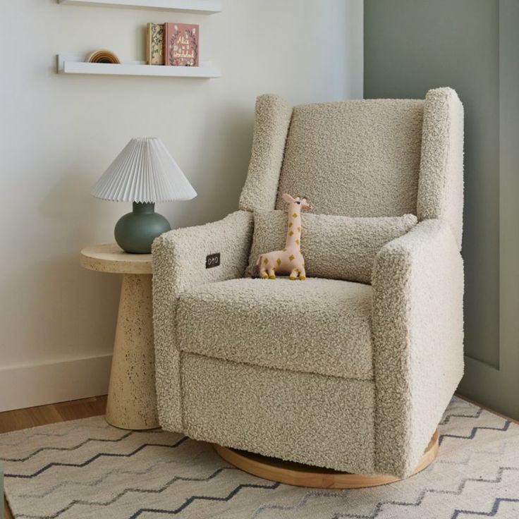 a rocking chair with a stuffed giraffe sitting on it's back in a living room