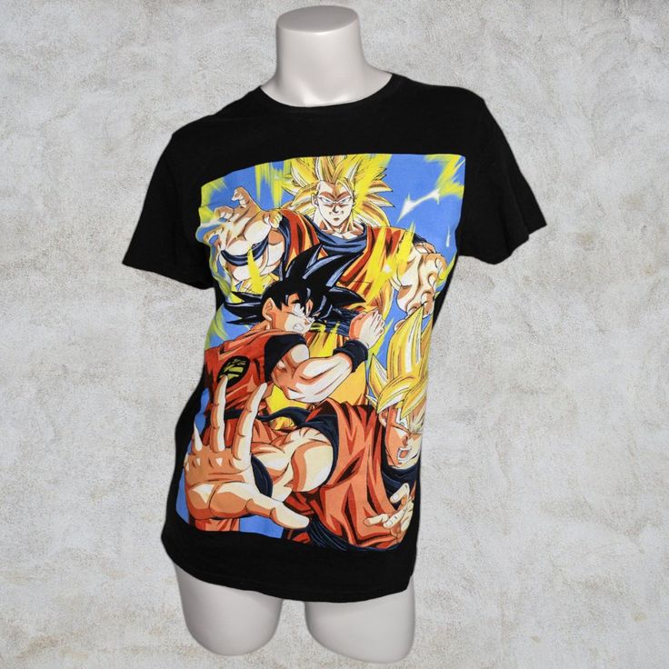 Dragonballz Black Tee Pre-Loved / Great Condition / Like New Color: Black Size: Small Material: 100% Cotton Measurements: -Bust- 18 1/2" -Length- 28" -Shoulders- 17 1/2" -Sleeve Length- 7" Extras: - Fitted - Unisex Thank You For Stopping By Dovey Duds. If You Ever Have Any Questions, Please Feel Free To Contact Me Anytime. Have A Wonderful Day :) Super Goku, Manga, Anime, Casual, Fitted, Animation, Colorful Black Tops With Screen Print For Fan Conventions, Black Screen Print Tops For Fan Conventions, Black Graphic Tee For Fan Conventions, Black Top With Cartoon Print For Cosplay, Black Graphic Print Top For Fan Conventions, Black Cartoon Print Top For Cosplay, Black Tops With Front Print For Fan Conventions, Black Top With Front Print For Fan Conventions, Black Short Sleeve Top For Fan Conventions