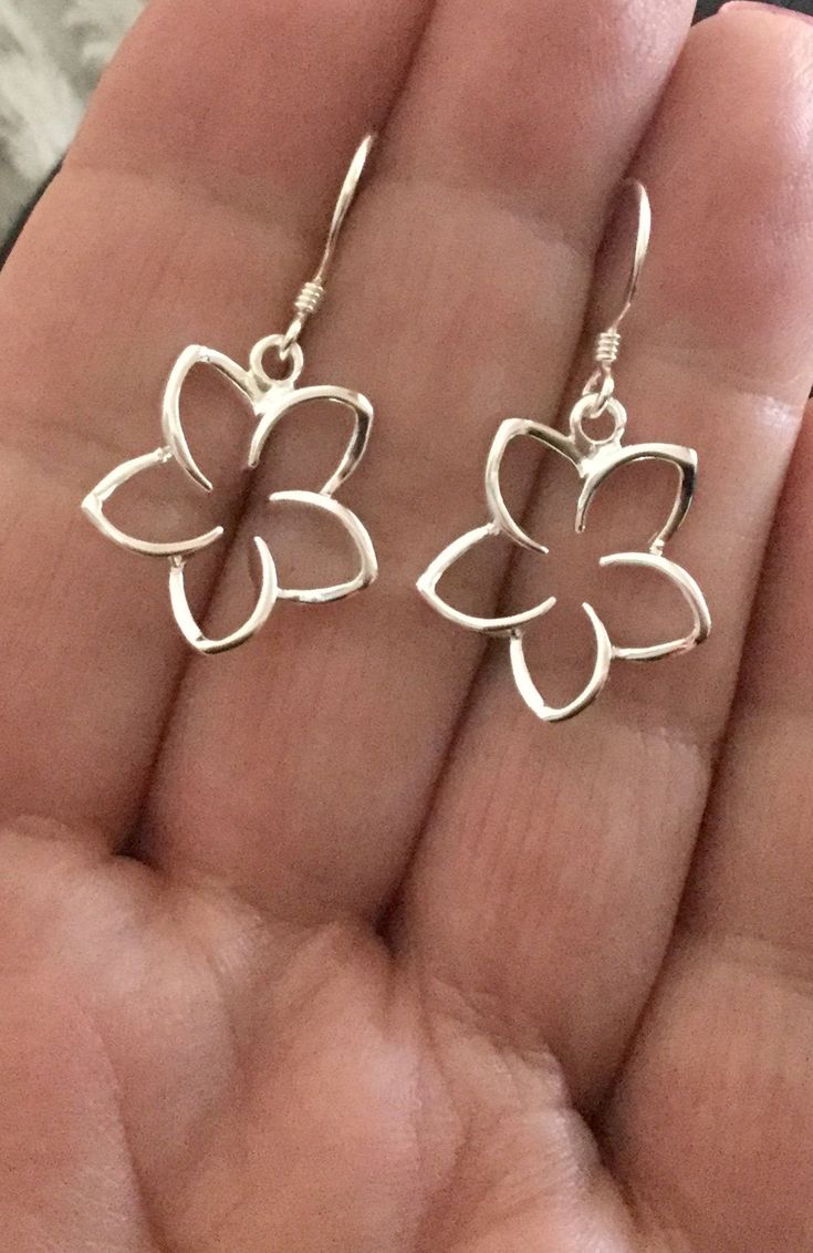 ".925 Sterling Silver Hawaiian Plumeria Large dangle Earrings. The size is 17MM, just under 3/4\". Top-selling collection in our Hawaii stores. The Highly-reflective Sterling finish is beautiful, nickel-free and long-lasting. These will shine for years to come. --The Plumeria is given here in Hawaii as a symbol of love and friendship. Handmade with Aloha in Maui. Packaged ready for gifting with a Hawaiian Plumeria story, Sterling silver cleaning instructions, jewelry pouch and gift box. Practice Sterling Silver Flower-shaped Jewelry With Matching Earrings, Silver Flower Jewelry With Matching Earrings, Sterling Silver Flower-shaped Earrings, White Sterling Silver Pierced Flower Earrings, Sterling Silver White Gold Flower Earrings For Gift, Flower Shaped Pierced Jewelry For Anniversary, Sterling Silver Drop Earrings For Anniversary, Gift White Gold Sterling Silver Flower Earrings, White Gold Sterling Silver Flower Earrings Gift