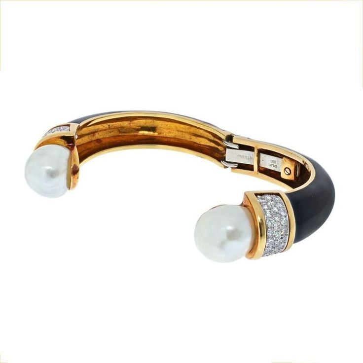 Indulge in the allure of elegance with the David Webb Platinum & 18K Yellow Gold Black Enamel and Pearl Diamond Bracelet. This exquisite piece captures the essence of timeless sophistication and artistry. Crafted with meticulous attention to detail, it showcases a harmonious blend of 18k yellow gold and platinum, creating a luxurious contrast that is sure to catch the eye.Drawing inspiration from the glamour of the 1970s, this hinged cuff bracelet boasts button cultured pearls and sparkling diam Elegant Polished Bangle, Elegant Yellow Gold Cuff Bracelet For Formal Occasions, Elegant Yellow Gold Bangle For Formal Occasions, Elegant Polished Gold Bracelet, Elegant Polished Finish Bangle For Evening, Elegant Polished Bangle For Evening, Elegant Evening Bangle With Polished Finish, Elegant Gold Bracelet With Polished Finish, Elegant Gold Bracelet With Polished Finish For Formal Occasions