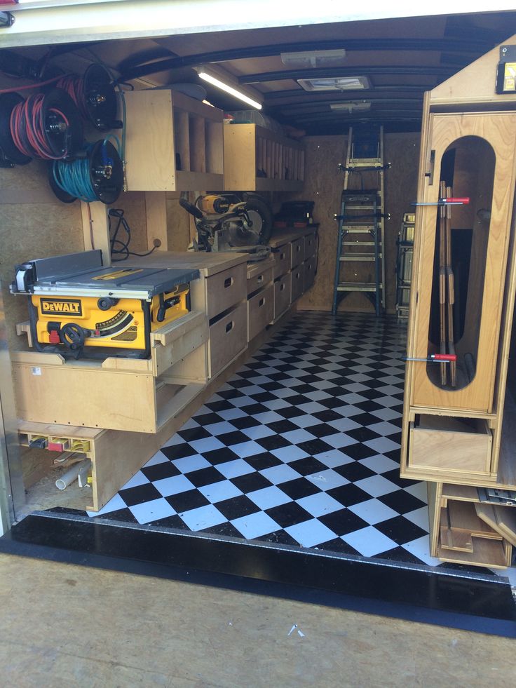 the inside of a garage with black and white checkered flooring on the ground