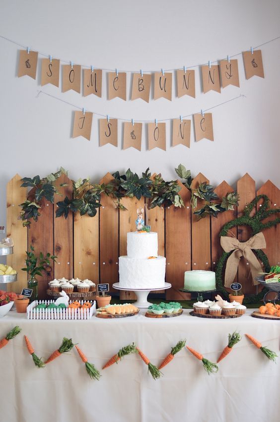 a table with carrots, cake and bunting banner