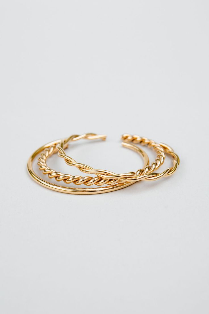 Introducing our stunning Neva cuff set, a playful and stylish addition to any jewelry collection. This set of stackable bracelets is expertly crafted from durable stainless steel and finished with a radiant 18k gold plating, creating a beautiful and eye-catching look.The Neva cuff set includes multiple bracelets that can be worn together for a bold and striking look or separately for a more subtle effect. The versatility of this set means that you can mix and match to create a variety of differe Chic Gold Stackable Cuff Bracelet, Trendy Stackable Bangle Jewelry, Stackable Double Band Gold Bracelets, Gold Stackable Double Band Bracelets, Chic Gold Stackable Bangle, Modern Gold-plated Stackable Bracelets, Trendy Stackable Gold Bangle Bracelet, Trendy Stackable Gold-plated Jewelry, Adjustable Modern Jewelry With Tarnish Resistance