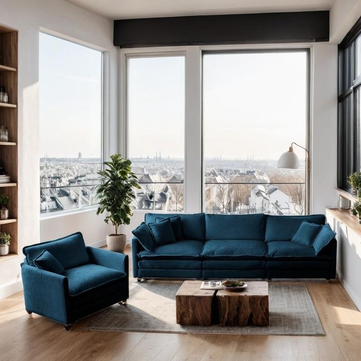 a living room filled with furniture next to large windows on top of a wooden floor