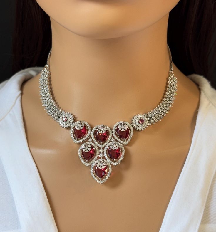 Ruby CZ diamond Necklace,Indian Pakistani wedding Jewelry,Mother of the Bride,Crystal Necklace, Bridesmaid, Gift for her Gorgeous Ruby CZ Set in aaa quality CZ stones. This American Diamond Necklace Set comes with a pair of earrings. Regular size and adjustable Arrives in a gift box. Highest quality and craftsmanship Ready to ship from California, United States and delivery in 3-5 days in US Please let me know if you have any questions. Thank you so much for visiting my shop. Color, shades, and Crystal Jewelry Sets For Anniversary On Valentine's Day, Crystal Jewelry Sets For Anniversary And Valentine's Day, Diamond White Cubic Zirconia Bridal Necklace With Jewels, Diamond White Bridal Necklace With Cubic Zirconia, Crystal Heart Jewelry For Wedding, Heart Cut Necklace For Wedding And Valentine's Day, Valentine's Day Wedding Necklace Heart Cut, Heart Cut Jewelry With Diamond Accents For Party, Heart Cut Diamond Jewelry For Wedding